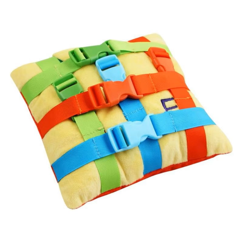 Colorful buckle sensory pillow with woven colorful straps on a white background
