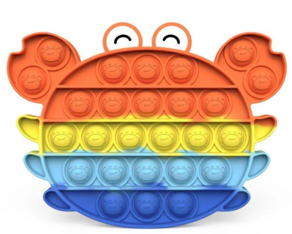 Colorful pop-it toy shaped like a crab on a white background