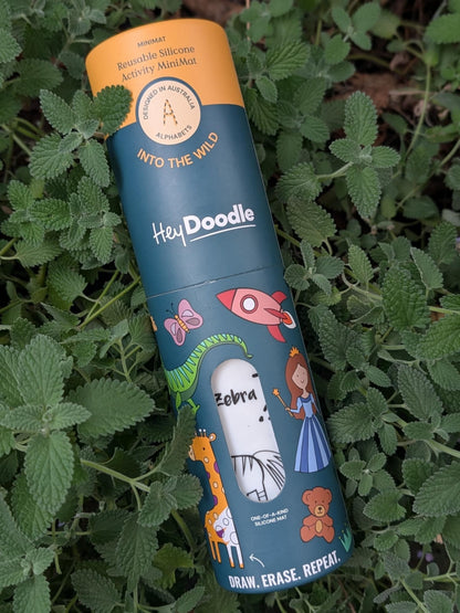 Hey Doodle Mini Reusable Mat packaging with 'Into the Wild' theme, featuring illustrations of animals and a child using a marker.